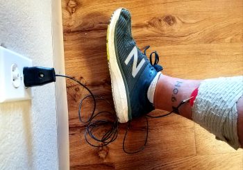 an athlete doing the grounding protocol with the Phoenix Waveform grounding or earthing attachement to aid in recovery and faster healing with the phoenix Waveform 