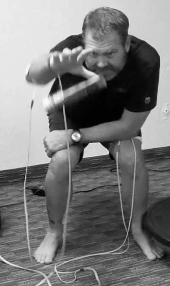Dr Jeff Banas demonstrating Phoenix Waveform neurotherapy during a lower-body treatment showing electrode placement and activation